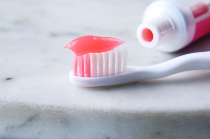 red toothpaste and toothbrush