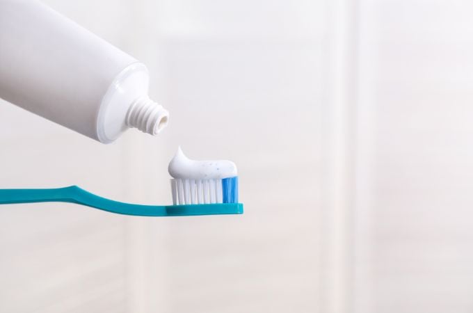 blue toothbrush with white toothpaste